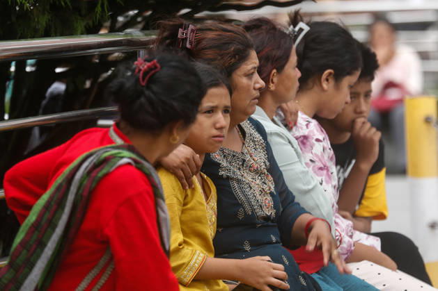 Nepal Floods - Aftermath Relatives of people missing after flash floods in Rasuwa and Nuwakot cry while searching for their loved ones at Tribhuvan University Teaching Hospital on August 30, 2026. Families examine photographs and missing-person notices as search and identification efforts continue. The floods destroyed homes and swept mud and debris downstream along the Trishuli River. Kathmandu Nepal Copyright: xSanjitxPariyarx originalFilename: pariyar-notitle260830_npCys