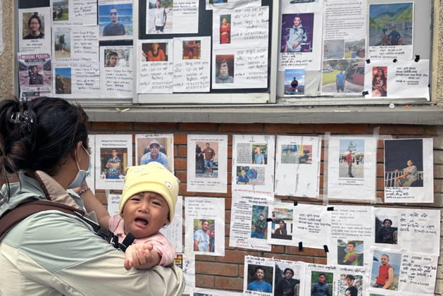 August 30, 2026, Kathmandu, Nepal: A woman along with her baby searches for missing family members as photographs of missing people are displayed outside the hospital, four days after devastating flash floods struck areas near the Nepal-China border at Tribhuvan University Teaching Hospital in Maharajgunj, Kathmandu,Nepal on August 30, 2026. According to authorities, 734 people had died and 2,498 remained missing as morning of Aug. 30, 2026, following devastating flash floods that struck areas near the Nepal-China border on Aug. 26. Kathmandu Nepal - ZUMAs233 20260830_zap_s233_010 Copyright: xSunilxSharmax