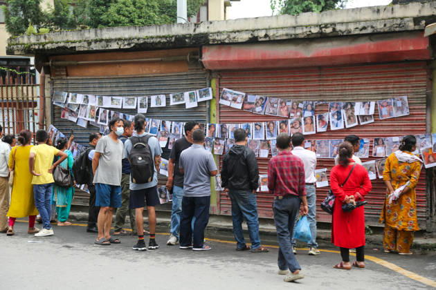 Passersby View Flood Victims Photos - Kathmandu Passersby look at photographs of people who died in the floods, displayed outside a hospital in Kathmandu, Nepal on August 30, 2026. Photo by Sunil Pradhan ABACAPRESS.COM Kathmandu Bagmati Nepal  Copyright: xSuniixPradhan ABACAx