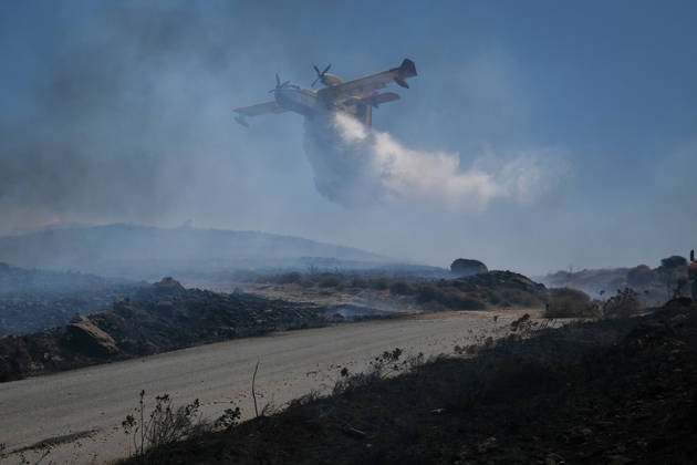 Wildfire burns near Karystos on Greece s Evia island KARYSTOS, GREECE - SEPTEMBER 2: A firefighting airplane drops water as a wildfire burns near Karystos on the island of Evia, Greece, on September 2, 2026. Costas Baltas Anadolu Karystos Greece. Editorial use only. Please get in touch for any other usage.  Copyright: x2026xAnadoluxCostasxBaltasx