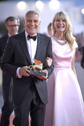 George Clooney poses on the red carpet with Laura Dern after receiving the Golden Lion for Lifetime Achievement Award during the Opening Ceremony the 83rd Venice International Film Festival at Sala Grande on September 2, 2026 in Venice, Italy.  VFF20260902870 RoccoxSpaziani