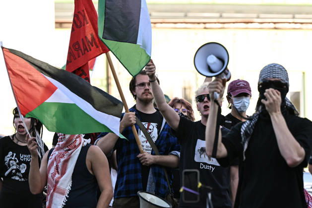 Anti-Israel Rally Outside Opening Day Of MSPO 2026 Defense Salon In Kielce KIELCE, POLAND - SEPTEMBER 8: Anti-Israel protesters wave Palestinian flags and use a megaphone to shout slogans behind a masked activist clad in black during a demonstration organized by the Expos Without Criminals ( Targi Bez Zbrodniarzy ) coalition outside the Targi Kielce exhibition center gates to demand the exclusion of Israeli weapons companies on the opening day of the 34th International Defence Industry Exhibition (MSPO) on September 8, 2026. Kielce Poland  Copyright: xArturxWidakx originalFilename: widak-antiisra260908_npjAo.jpg
