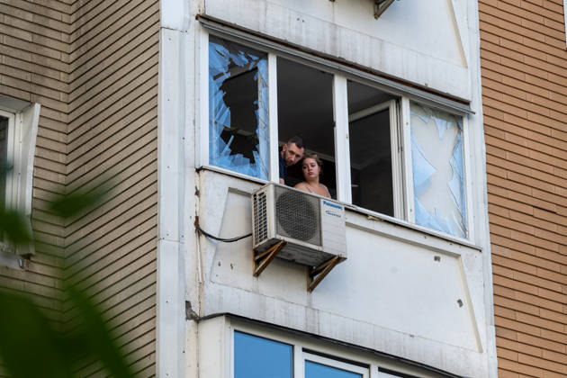 A man and a woman look out from a balcony in a 24-storey apartment block damaged by a Russian attack in the Darnytskyi district of Kyiv, Ukraine, September 9, 2026. On Wednesday morning, September 9, a Russian drone hit the 24-storey building on the 12th floor. According to police, five people were injured, including a pregnant woman. (Photo by Danylo Antoniuk Ukrinform) Apartment block hit by Russian drone in Kyiv  Copyright: xDanyloxAntoniukx