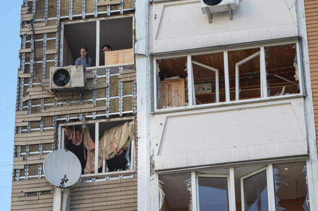 A man and a woman stand in a shattered window in a 24-storey apartment block damaged by a Russian attack in the Darnytskyi district of Kyiv, Ukraine, September 9, 2026. On Wednesday morning, September 9, a Russian drone hit the 24-storey building on the 12th floor. According to police, five people were injured, including a pregnant woman. (Photo by Danylo Antoniuk Ukrinform) Apartment block hit by Russian drone in Kyiv  Copyright: xDanyloxAntoniukx