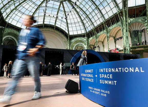 (260909) -- PARIS, Sept. 9, 2026 -- A visitor passes the logo of the International Space Summit at the Grand Palais in Paris, France, Sept. 9, 2026. The first International Space Summit opened Wednesday in Paris, bringing together heads of state and government, scientists, astronauts and industry representatives. ) FRANCE-PARIS-INTERNATIONAL SPACE SUMMIT WuxHuiwo 