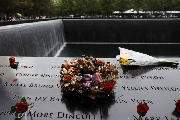 lowers are left at the memorial during a remembrance ceremony marking the 25th anniversary of the 9 11 attacks at the National September 11 Memorial & Museum at Ground Zero in New York on Friday, September 11, 2026. A total of 2,753 people died in the attack on the World Trade Center on September 11, 2001. Pool  WAX20260911965 SpencerxPlatt