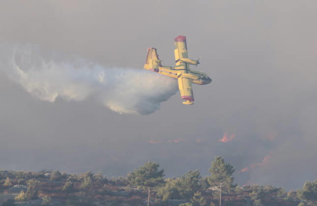 Croatia Island Wildfire A Croatian Canadair CL-415 firefighting plane drops water on a wildfire near city Milna at Island Brac, Croatia on September 12, 2026.  IvoxCagalj PIXSELL