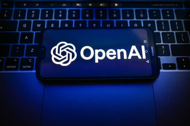 Tech illustrations in Poland - 25 Sept 2026 In this photo illustration, an OpenAI logo is seen displayed on a smartphone on the top of a laptop. Poland Copyright: xOmarxMarquesx xSOPAxImagesx omarques_25092026_TECHPOL-13