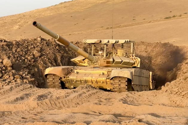TAJIKISTAN - OCTOBER 3, 2026: Russian tank crews destroy a simulated enemy during the Tsentr Centre 2026 military exercise held at the Lyaur training ground. Video screen grab. Best quality available. Russian Defence Ministry TASS  98708959