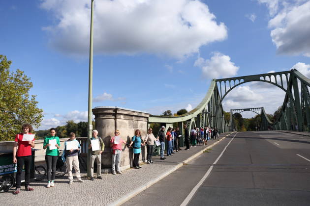 Demonstranten während einer Menschenkette für Klimaschutz und Demokratie auf der Glienicker Brücke in Potsdam, 3. Oktober 2026. Es brennt! Menschenkette Potsdam