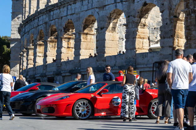 Ferrari Tour stops in Pula Luxury Ferrari sports cars taking part in a Ferrari Tour organized by Ineco Auto, are seen in front of the Roman Arena in Pula, Croatia, on October 3, 2026. While the drivers visit the ancient amphitheatre, local residents gather to watch and admire the vehicles.  SreckoxNiketic PIXSELL