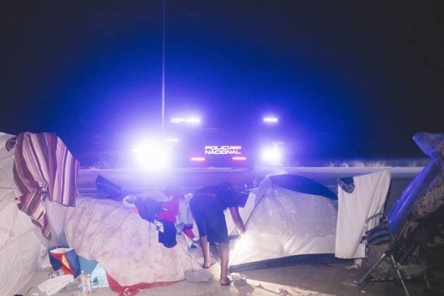 October 3, 2026, Ceuta, Ceuta, Spain: The lights of a police van shine behind a tent at a makeshift migrant camp in Ceuta at night. Riot police escorted firefighters through the camp on the night of October 3 to put out the fires that people living there use to cook their food. Thousands of migrants, most of them young Moroccan men, have been living in makeshift settlements in the Spanish North African enclave of Ceuta since a mass arrival at the end of July 2026 set off a migration and political crisis. Ceuta Spain - ZUMAs392 20261003_zip_s392_007 Copyright: xFabianxSuspensivox