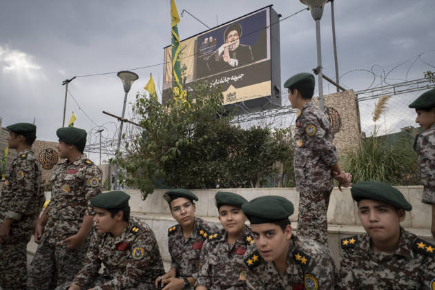 Opening Ceremony Of Second City-Square Military Training Camp Iranian schoolboys wearing military uniforms gather beneath a portrait of Hassan Nasrallah, the late secretary general of Lebanon s Hezbollah, as they prepare to take part in the opening ceremony of the second city-square military training camp for self-sacrificing forces in downtown Tehran, Iran, on October 3, 2026. The camp was established by the Basij paramilitary force, with personnel from the Islamic Republic of Iran Army responsible for training the volunteers. Tehran Tehran Iran  Copyright: xMortezaxNikoubazlx originalFilename: nikoubazl-openingc261003_np5QQ.jpg