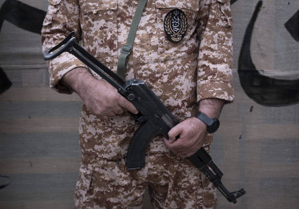 Opening Ceremony Of Second City-Square Military Training Camp A member of the Islamic Revolutionary Guard Corps (IRGC) attaches a badge for self-sacrificing forces to his uniform while holding a rifle and standing guard during the opening ceremony of the second city-square military training camp in downtown Tehran, Iran, on October 3, 2026. The camp was established by the Basij paramilitary force, with personnel from the Islamic Republic of Iran Army responsible for training the volunteers. Tehran Tehran Iran  Copyright: xMortezaxNikoubazlx originalFilename: nikoubazl-openingc261003_npNwq.jpg