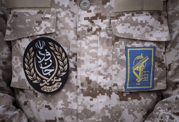 Opening Ceremony Of Second City-Square Military Training Camp A member of the Islamic Revolutionary Guard Corps (IRGC) attaches a badge for self-sacrificing forces to his uniform while standing guard during the opening ceremony of the second city-square military training camp in downtown Tehran, Iran, on October 3, 2026. The camp was established by the Basij paramilitary force, with personnel from the Islamic Republic of Iran Army responsible for training the volunteers. Tehran Tehran Iran  Copyright: xMortezaxNikoubazlx originalFilename: nikoubazl-openingc261003_npNZd.jpg