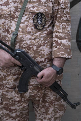 Opening Ceremony Of Second City-Square Military Training Camp A member of the Islamic Revolutionary Guard Corps (IRGC) attaches a badge for self-sacrificing forces to his uniform while holding a rifle and standing guard during the opening ceremony of the second city-square military training camp in downtown Tehran, Iran, on October 3, 2026. The camp was established by the Basij paramilitary force, with personnel from the Islamic Republic of Iran Army responsible for training the volunteers. Tehran Tehran Iran  Copyright: xMortezaxNikoubazlx originalFilename: nikoubazl-openingc261003_npXnf.jpg