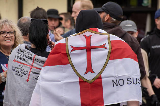 October 3, 2026, Dover, United Kingdom: A couple wrapped in St George s flags during a demonstration in Dover. Supporters of the English Defence League (EDL) gathered in Dover, UK to march through the town all the way to the harbour. English Defence League is an extreme far-right and Islamophobic organisation. It was founded by Tommy Robinson (pseudonym of Steven Yaxley-Lennon) in 2009. Dover United Kingdom - ZUMAs197 20261003_aaa_s197_253 Copyright: xKrisztianxElekx