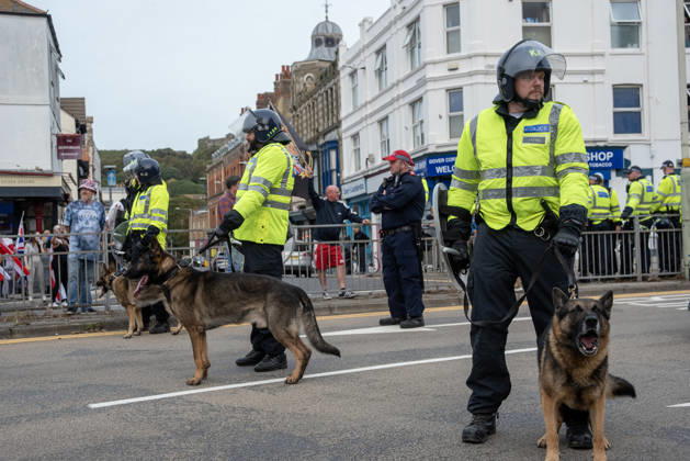 October 3, 2026, Dover, United Kingdom: Members of the police dog unit with their German Shepherds keep clear the road during a demonstration in Dover. Supporters of the English Defence League (EDL) gathered in Dover, UK to march through the town all the way to the harbour. English Defence League is an extreme far-right and Islamophobic organisation. It was founded by Tommy Robinson (pseudonym of Steven Yaxley-Lennon) in 2009. Dover United Kingdom - ZUMAs197 20261003_aaa_s197_262 Copyright: xKrisztianxElekx