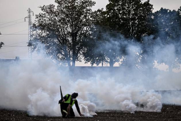 PROTEST AGAINST PESTICIDES PHOTOPQR OUEST FRANCE Martin ROCHE Saint Pierre la Garenne October 3, 2026 This Saturday, October 3, 2026, a protest against pesticides is being held in Saint-Pierre-la-Garenne, Eure, Normandy. In the massive procession, farmers, patients, healthcare workers, and citizens demanded the closure of production sites such as Syngenta’s. The rally was organized by an unprecedented coalition: the Confédération paysanne, Les Soulèvements de la Terre, the Cancer Colère association, and the Collectif de soutien aux victimes des pesticides de l’Ouest (CSVPO). Here, protesters face the large police presence separating them from the Syngenta factory, were quickly tear-gassed with numerous tear gas canisters and GM2L gre  Copyright: xPHOTOPQR OUESTxFRANCE MAXPPPxMartinxROCHEx 20261004OFR7226 20261004OFR7226