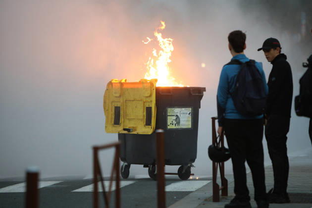 October 5, 2026, Anglet, Nouvelle Aquitaine, France: Youths look on as a waste container burns during a protest by high school students against the government outside the Cantau high school in Anglet, southwestern France, on October 5, 2026. Students have been blocking schools across France since September 21 to demand more teachers, smaller classes and better school buildings. Cantau was closed by authorities after clashes in recent days. Anglet France  - ZUMAb298 20261005_zsp_b298_009 Copyright: xJulesxBuonx