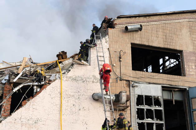 October 5, 2026, Kharkiv, Kharkiv Oblast, Ukraine: Local rescue workers, firefighters and Red Cross volunteers clear rubble following a Russian aerial attack on a bus repair warehouse which killed two people in Kharkiv, Ukraine. Emergency crews search through the heavily damaged building and collapsed sections of the warehouse for survivors and the remains of those killed in the attack. Kharkiv Ukraine - ZUMAm350 20261005_zip_m350_002 Copyright: xCameronxJones-Manleyx