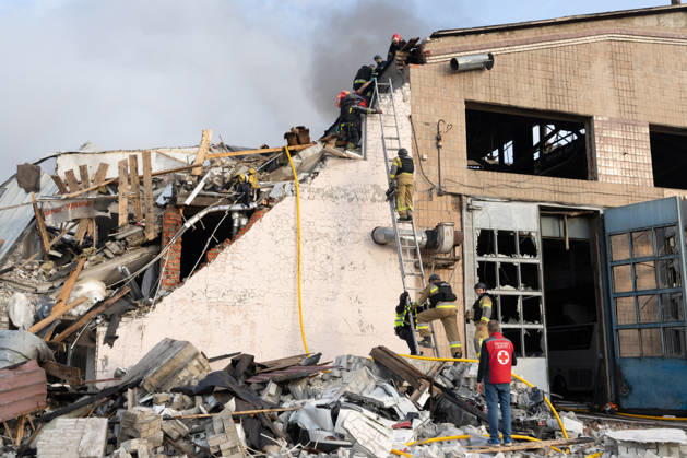 October 5, 2026, Kharkiv, Kharkiv Oblast, Ukraine: Local rescue workers, firefighters and Red Cross volunteers clear rubble following a Russian aerial attack on a bus repair warehouse which killed two people in Kharkiv, Ukraine. Emergency crews search through the heavily damaged building and collapsed sections of the warehouse for survivors and the remains of those killed in the attack. Kharkiv Ukraine - ZUMAm350 20261005_zip_m350_003 Copyright: xCameronxJones-Manleyx
