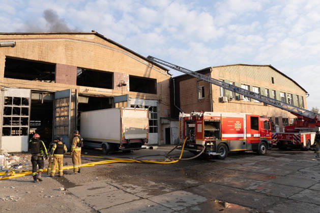 October 5, 2026, Kharkiv, Kharkiv Oblast, Ukraine: Local rescue workers, firefighters and Red Cross volunteers clear rubble following a Russian aerial attack on a bus repair warehouse which killed two people in Kharkiv, Ukraine. Emergency crews search through the heavily damaged building and collapsed sections of the warehouse for survivors and the remains of those killed in the attack. Kharkiv Ukraine - ZUMAm350 20261005_zip_m350_008 Copyright: xCameronxJones-Manleyx