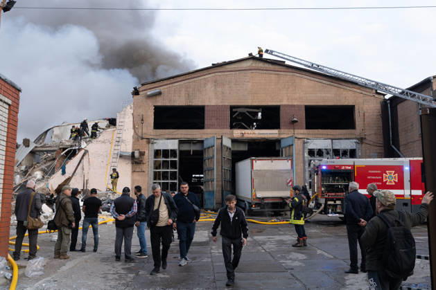 October 5, 2026, Kharkiv, Kharkiv Oblast, Ukraine: Local rescue workers, firefighters and Red Cross volunteers clear rubble following a Russian aerial attack on a bus repair warehouse which killed two people in Kharkiv, Ukraine. Emergency crews search through the heavily damaged building and collapsed sections of the warehouse for survivors and the remains of those killed in the attack. Kharkiv Ukraine - ZUMAm350 20261005_zip_m350_013 Copyright: xCameronxJones-Manleyx