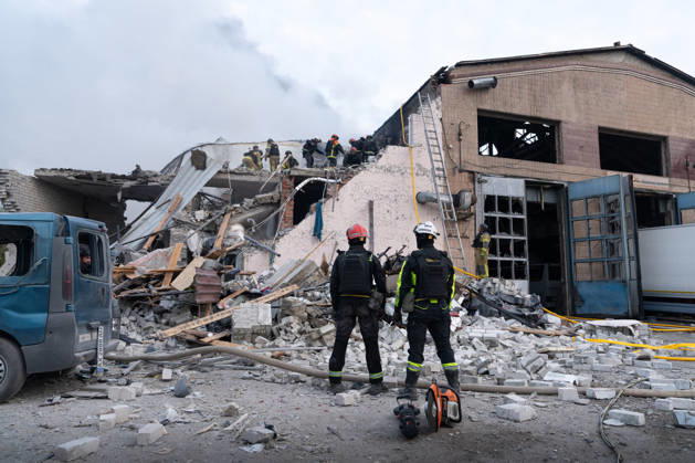 October 5, 2026, Kharkiv, Kharkiv Oblast, Ukraine: Local rescue workers, firefighters and Red Cross volunteers clear rubble following a Russian aerial attack on a bus repair warehouse which killed two people in Kharkiv, Ukraine. Emergency crews search through the heavily damaged building and collapsed sections of the warehouse for survivors and the remains of those killed in the attack. Kharkiv Ukraine - ZUMAm350 20261005_zip_m350_014 Copyright: xCameronxJones-Manleyx