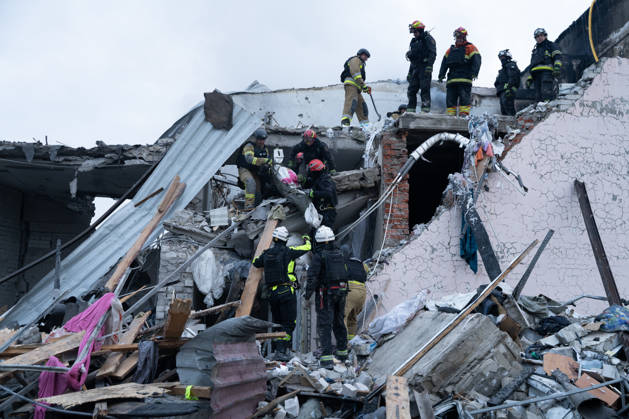 October 5, 2026, Kharkiv, Kharkiv Oblast, Ukraine: Local rescue workers, firefighters and Red Cross volunteers clear rubble following a Russian aerial attack on a bus repair warehouse which killed two people in Kharkiv, Ukraine. Emergency crews search through the heavily damaged building and collapsed sections of the warehouse for survivors and the remains of those killed in the attack. Kharkiv Ukraine - ZUMAm350 20261005_zip_m350_015 Copyright: xCameronxJones-Manleyx
