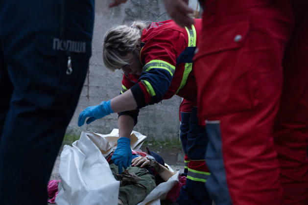 October 5, 2026, Kharkiv, Kharkiv Oblast, Ukraine: Local rescue workers identify the body of a woman following a Russian aerial attack on a bus repair warehouse in Kharkiv, Ukraine. Two people were killed in the attack, while emergency crews, firefighters and Red Cross volunteers worked to clear the rubble and search the damaged site. Kharkiv Ukraine - ZUMAm350 20261005_zip_m350_018 Copyright: xCameronxJones-Manleyx