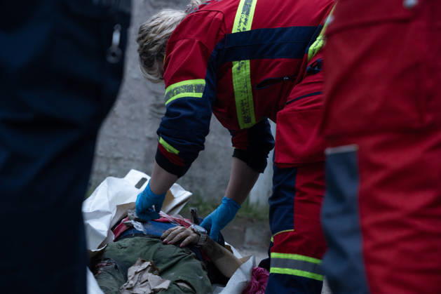 October 5, 2026, Kharkiv, Kharkiv Oblast, Ukraine: Local rescue workers identify the body of a woman following a Russian aerial attack on a bus repair warehouse in Kharkiv, Ukraine. Two people were killed in the attack, while emergency crews, firefighters and Red Cross volunteers worked to clear the rubble and search the damaged site. Kharkiv Ukraine - ZUMAm350 20261005_zip_m350_019 Copyright: xCameronxJones-Manleyx