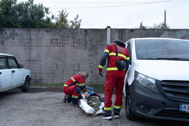 October 5, 2026, Kharkiv, Kharkiv Oblast, Ukraine: Local rescue workers identify the body of a woman following a Russian aerial attack on a bus repair warehouse in Kharkiv, Ukraine. Two people were killed in the attack, while emergency crews, firefighters and Red Cross volunteers worked to clear the rubble and search the damaged site. Kharkiv Ukraine - ZUMAm350 20261005_zip_m350_022 Copyright: xCameronxJones-Manleyx