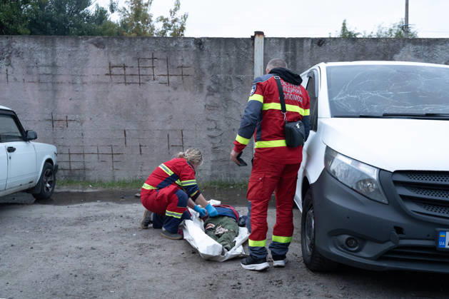 October 5, 2026, Kharkiv, Kharkiv Oblast, Ukraine: Local rescue workers identify the body of a woman following a Russian aerial attack on a bus repair warehouse in Kharkiv, Ukraine. Two people were killed in the attack, while emergency crews, firefighters and Red Cross volunteers worked to clear the rubble and search the damaged site. Kharkiv Ukraine - ZUMAm350 20261005_zip_m350_023 Copyright: xCameronxJones-Manleyx