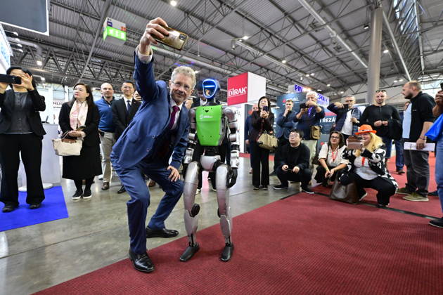 Czech Senate President Milos Vystrcil takes a selfie with a humanoid robot at opening of the 67th International Engineering Fair, which begins at Vystaviste 1 exhibition grounds in Brno, Czech Republic, on October 6th, 2026. International Fair of Machine Tools and Forming Machines IMT, International Welding Engineering Fair Welding, International Fair of Plastics, Rubber and Composites Plastex, International Fair of Surface Treatment Technologies Profintech and International Foundry Fair Fond-Ex also start. (CTKxPhoto VaclavxSalek) CTKPhotoP2026100603482  CTKPhotoP2026100603482