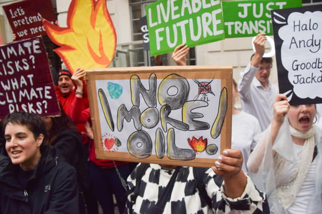 October 6, 2026, London, England, United Kingdom: An activist holds a No More Oil placard during a protest by the climate action group Fossil Free London against the Rosebank oil field and the Jackdaw gas field outside the Department for Energy Security and Net Zero. London United Kingdom  - ZUMAv130 20261006_zip_v130_009 Copyright: xVukxValcicx