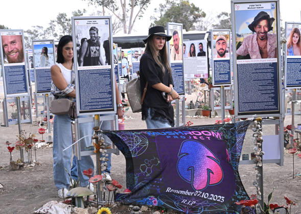People look at photos of hundreds of victims killed by Hamas on October 7, 2023, at the Nova Festival Memorial site in Re im, near the Gaza border on Monday, October 6, 2026. Israel is marking three years since the Hamas attack that killed 1,200 people and 251 were taken hostage into Gaza.  JER2026100612 DEBBIExHILL