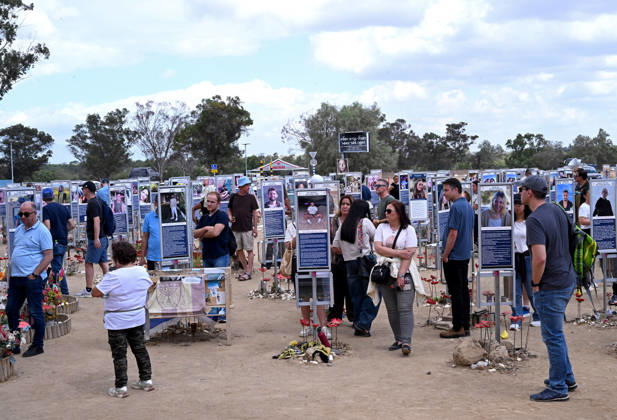 People look at photos of hundreds of victims killed by Hamas on October 7, 2023, at the Nova Festival Memorial site in Re im, near the Gaza border on Monday, October 6, 2026. Israel is marking three years since the Hamas attack that killed 1,200 people and 251 were taken hostage into Gaza.  JER2026100604 DEBBIExHILL