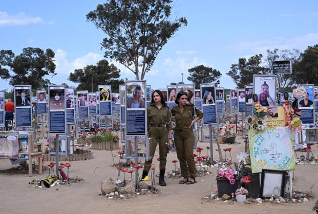 Israeli soldiers look at photos of hundreds of victims killed by Hamas on October 7, 2023, at the Nova Festival Memorial site in Re im, near the Gaza border on Monday, October 6, 2026. Israel is marking three years since the Hamas attack that killed 1,200 people and 251 were taken hostage into Gaza.  JER2026100608 DEBBIExHILL