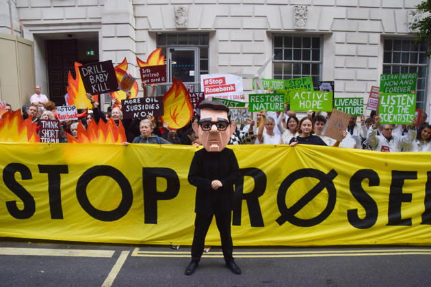 October 6, 2026, London, England, United Kingdom: Activists from the group Fossil Free London stage a protest against the Rosebank oil field and the Jackdaw gas field outside the Department for Energy Security and Net Zero. Activists dressed as angels urge a protester wearing an Andy Burnham mask to stop the fossil fuel projects in the North Sea while activists dressed as devils urge him to drill for more oil. London United Kingdom  - ZUMAv130 20261006_zip_v130_060 Copyright: xVukxValcicx