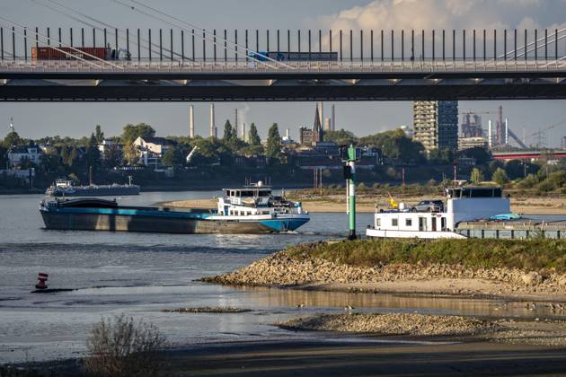 Extremes Niedrigwasser am Rhein, hier zwischen DU-Neuenkamp und DU-Ruhrort, Rheinbrücke Neuenkamp, Autobahn A40, LKW Verkehr, trocken gefallenes Ufer, Pegel zur Zeit der Aufnahme bei 131cm in DU-Ruhrort, über 20cm unter der bisherigen je gemessnen Tiefstmarke von 2018, starke Einschränkungen für die Binnenschifffahrt, im Hintergrund die Friedrich-Eber-Brücke über den Rhein bei DU-Ruhrort, NRW, Deutschland Rhein Niedrigwasser
