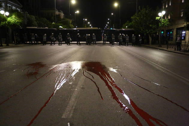 October 6, 2026, Athens, Attica, GREECE: Red paint symbolizing bloodshed in US wars covers the street in front of a police line during an anti-war demonstration opposing the visit of US Secretary of State MARCO RUBIO. Athens GREECE - ZUMAx103 20261006_zip_x103_025 Copyright: xHarrisxXanthopoulosx