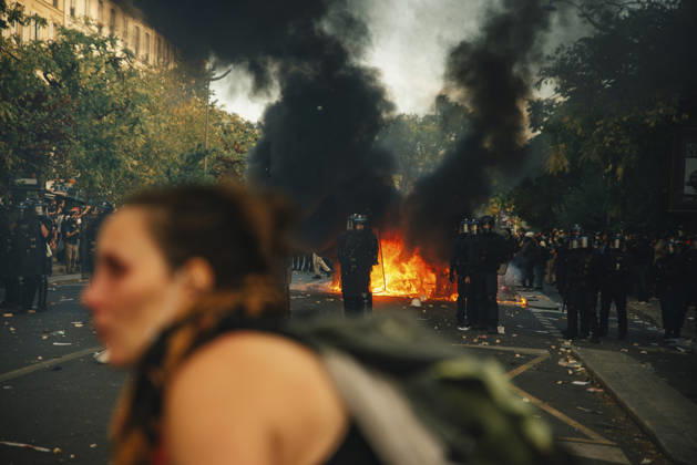Paris Students Protest Education Conditions A demonstrator passes in the foreground as flames and black smoke rise behind her in Paris, France, on October 6, 2026. France s Interior Ministry said 256,000 people marched nationwide, including 56,000 in Paris, during the student-led day of action over school conditions. High school students called for more education funding and staff, smaller classes and improved facilities, with teachers, parents and unions joining demonstrations. Paris Ile de France France Copyright: xDavoodxMaeilix