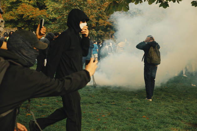 Paris Students Protest Education Conditions A masked demonstrator runs across grass as journalists and other protesters look on in Paris, France, on October 6, 2026. France s Interior Ministry said 256,000 people marched nationwide, including 56,000 in Paris, during the student-led day of action over school conditions. High school students called for more education funding and staff, smaller classes and improved facilities, with teachers, parents and unions joining demonstrations. Paris Ile de France France Copyright: xDavoodxMaeilix