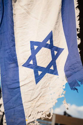 October 7, 2026, Tel Aviv, Tel Aviv, Israel: A tattered Israeli flag is held up in protest against the Israeli government on the third anniversary of October 7th. Tel Aviv Israel - ZUMAg280 20261007_znp_g280_002 Copyright: xYoavxGinsburgx