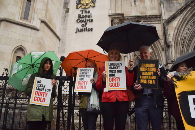 October 7, 2026, London, England, United Kingdom: Campaigners stand outside the Royal Courts of Justice as the legal case against the London Bullion Market Association begins. The LBMA is accused of incorrectly certifying gold from TanzaniaÃ¢â‚¬â ¢s North Mara mine as clean , despite reported human rights abuses connected to the mine. The case is being brought by the families of two Tanzanian men who were killed at the gold mine. London United Kingdom - ZUMAv130 20261007_zip_v130_002 Copyright: xVukxValcicx