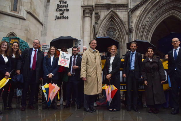 October 7, 2026, London, England, United Kingdom: Barrister and former Attorney General DOMINIC GRIEVE KC (centre) stands with the legal team and campaigners outside the Royal Courts of Justice as the legal case against the London Bullion Market Association begins. The LBMA is accused of incorrectly certifying gold from TanzaniaÃ¢â‚¬â ¢s North Mara mine as clean , despite reported human rights abuses connected to the mine. The case is being brought by the families of two Tanzanian men who were killed at the gold mine. London United Kingdom - ZUMAv130 20261007_zip_v130_007 Copyright: xVukxValcicx