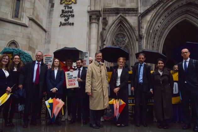 October 7, 2026, London, England, United Kingdom: Barrister and former Attorney General DOMINIC GRIEVE KC (centre) stands with the legal team and campaigners outside the Royal Courts of Justice as the legal case against the London Bullion Market Association begins. The LBMA is accused of incorrectly certifying gold from TanzaniaÃ¢â‚¬â ¢s North Mara mine as clean , despite reported human rights abuses connected to the mine. The case is being brought by the families of two Tanzanian men who were killed at the gold mine. London United Kingdom - ZUMAv130 20261007_zip_v130_010 Copyright: xVukxValcicx