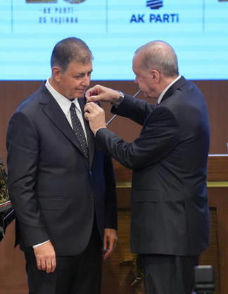 Legislative Year Opening Meeting with AK Party Deputies ANKARA, TURKIYE - OCTOBER 7: Turkish President and Leader of the Justice and Development (AK) Party Recep Tayyip Erdogan (R) pins the party badge on Izmir Metropolitan Municipality Mayor Cemil Tugay (L), who joined the AK Party, during the Legislative Year Opening Meeting with AK Party Deputies at the AK Party Congress Center in Ankara, Turkiye on October 7, 2026. Ercin Erturk Anadolu Ankara Turkey. Editorial use only. Please get in touch for any other usage.  Copyright: x2026xAnadoluxErcinxErturkx