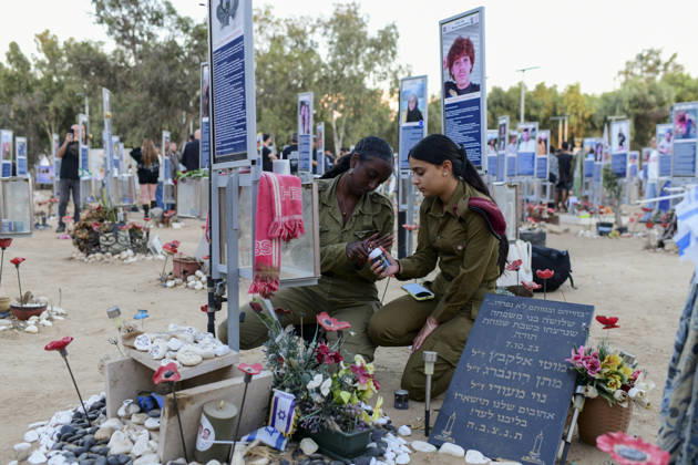Reim Nova Memorial Marks Anniversary Two women kneel beside a memorial covered with flowers, candles and personal items at the Nova music festival memorial site near Reim, southern Israel, on October 7, 2026. The Hamas-led attack on Israel on October 7, 2023, killed about 1,200 people and saw 251 taken hostage; more than 350 people were killed at the Nova festival. Memorial events marking the third anniversary were held at the site throughout the day. Reim Southern District Israel Copyright: xTomerxNeubergx